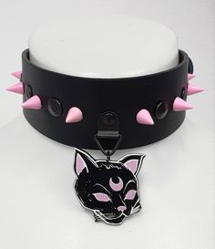 Genuine black leather, 40mm wide. Roller buckle in the back for closing. Acrylic witchy cat pendant. Pink spikes, 10mm high. Comfortable and easy to wear. Style: kawaii, harajuku, grunge, punk rock, witchy, gothic Adjustable Emo Choker For Cosplay, Black Punk Choker For Cosplay, Handmade Edgy Choker For Halloween, Edgy Black Choker For Cosplay, Cute Adjustable Black Choker, Genderfluid Outfits, Kawaii Choker, Gothic Kawaii, Witchy Cat