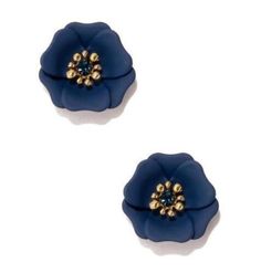 two blue flower shaped earrings with gold beads on top of each earring, one in the shape of a flower