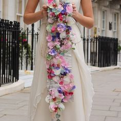 a woman in a white dress holding a bouquet of flowers