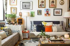 a living room filled with lots of furniture and pictures on the wall above it's coffee table