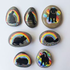 painted rocks with animals and rainbows on them