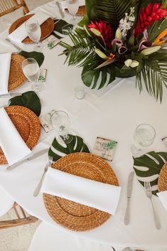 the table is set with white linens and place settings