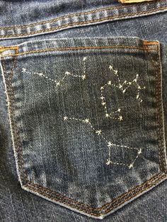 the back pocket of a pair of jeans with stars on it and an arrow in the middle