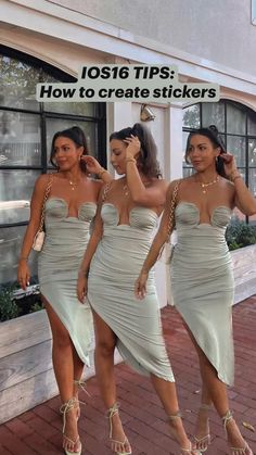 three women in dresses are walking down the street