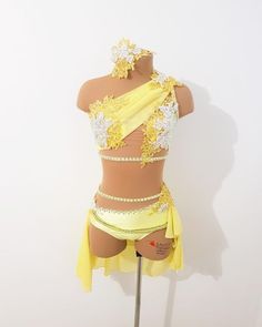 a mannequin dressed in yellow and white clothing