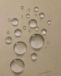 some water drops are on the table and it looks like they have been drawn by someone