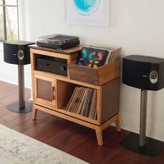 an entertainment center with record players and speakers