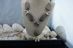 "This is the perfect option for those who like cool, unique jewelry and the luxury, shine of silver, brown. This necklace is well made, cute and/or elegant in design, and very desirable. Its style is a Sautoir, with its beautiful Petrified Wood stones and 4 dangles of genuine champagne pearls hanging 2-1/2 inches from a square bronze glass bead. See all our pictures. Going up each side of the main necklace are brownstones with lots of matrices. They are expertly matched on each side, on sterling Brown Dangle Jewelry With Natural Stones, Brown Jewelry With Natural Stones As Gift, Brown Natural Stone Jewelry For Gifts, Brown Dangle Earrings With Natural Stones, Brown Natural Stone Dangle Jewelry, Brown Natural Stone Dangle Earrings, Brown Natural Stone Jewelry As A Gift, Brown Spiritual Dangle Jewelry, Brown Natural Stone Jewelry Gift