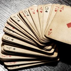 a pile of playing cards sitting on top of a table