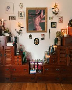 a room filled with lots of wooden furniture and pictures on the wall above it's drawers