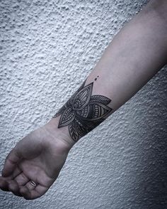 a black and white photo of a person's arm with a tattoo on it