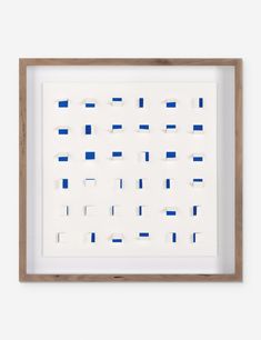 a white frame with blue squares on the bottom and one square in the middle, against a white wall