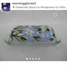 a glass dish with blue flowers on it