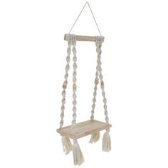 a wooden shelf with beads and tassels hanging from it's sides on a white background