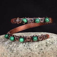 The unique free-form design of this spectacular wrap bracelet draws inspiration from rich Armenian art. Artisans Hasmik and Musheg create this alluring accessory that seamlessly blends copper wires and textured sheets with a captivating antique finish, adorned with enchanting malachite beads.