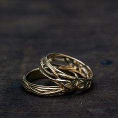 two gold rings sitting on top of each other