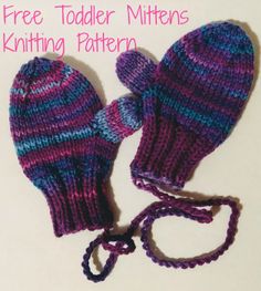 two knitted mittens are laying next to each other