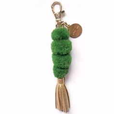 a key chain with a green pom - pom on it