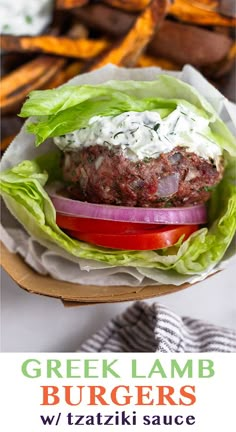 a hamburger with lettuce and tomatoes on it