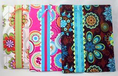 four colorful notebooks lined up on top of each other