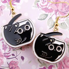 Hilarious and ridiculously cute, these black-cats-in-goldfish-bowls earrings will put a huge smile on anyone's face! All cat lovers know that felines will try and fit in any container, whether it's a cardboard box or a goldfish bowl, and they all look adorably silly doing it!! These are lightweight, fairly small earrings but by no means tiny: 26 mm or .98 of an inch long, by 24 mm or .94 of an inch wide. The nickel-free enamel-coated zinc alloy charms are hung on nickel-free hypoallergenic golde