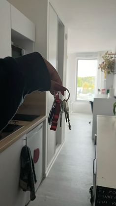 a person is holding keys in the kitchen