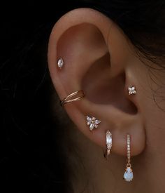 a close up of a person's ear with three different types of piercings