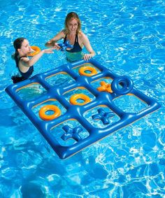 two girls playing with an inflatable pool game