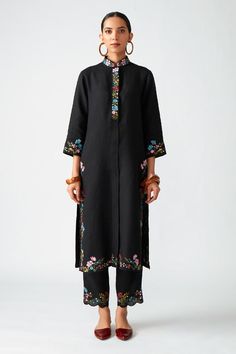 Black kurta with floral embroidered motifs, side slits and oversized placket. Paired with cropped scallop hem pant.
Component: 2
Pattern: Embroidered
Type Of Work: Floral motifs, Thread work
Neckline: Mandarin collar
Sleeve Type: Three-quarter sleeves
Fabric: Linen
Color: Black
Other Details: 
Side slits
Scallop hem pant
Oversized placket
Embroidered motifs
Occasion: Party - Aza Fashions Payal Pratap, How To Hem Pants, Indian Fashion Designers, Kurta With Pants, Clothing Websites, Desi Fashion, Black Linen, Floral Motifs, Pant Set