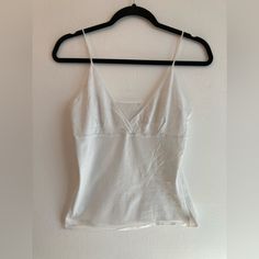 Exactly That. A White Camisole Top With No Tags Or Size. It’s Adorable! Never Worn. I’d Guess It’s A Size Medium From The Gap Lingerie Section. Cotton V-neck Tank Top With Built-in Bra, Fitted V-neck Tank Top For Daywear, Fitted Casual Camisole For Daywear, Fitted Tank Strap Tops For Daywear, Fitted Tops With Tank Straps For Daywear, Fitted Tank Tops For Day, Seamless Cami Top For Daywear, Fitted Bra-friendly Tops For Daywear, White Seamless V-neck Camisole