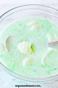 a glass bowl filled with green and white liquid