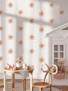 a small table and chairs in front of a wallpapered room with flowers on it