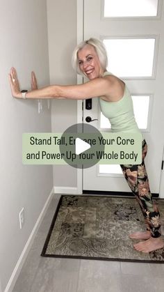 a woman standing in front of a door with her arms stretched out and the words, stand tall, ent your core and power up your whole body