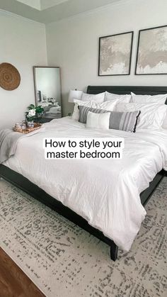 a bed with white sheets and pillows in a bedroom next to two pictures on the wall