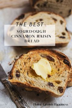 bread with butter and raisins on it sitting next to a knife that has been cut in half