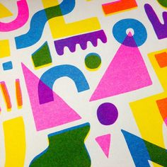 an abstract pattern with different shapes and colors on a white paper sheet that has been cut into smaller pieces