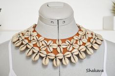 African cowrie shell necklace handmade necklace tribal necklace leather necklace African jewelry African fashion tribal accessories gift PRODUCT SPECIFICATIONS: Necklace length - 44.0 cm. Closure - press stud Materials - cowrie shells, brown leather, press stud ADDITIONAL INFORMATION New and unworn: Yes Handmade in Kenya: Yes Other jewelry in my shop: https://www.etsy.com/shop/shakava African Cowrie Shell Jewelry, Bohemian Brown Cowrie Shell Jewelry, Handmade Brown Cowrie Shell Jewelry, Handmade Brown Choker For Beach, Handmade Cowrie Shell Choker For Festivals, Cowrie Shell Jewelry, Cowrie Shell Necklace, Cowry Shell, Necklace Leather