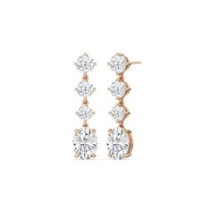 These diamond danglers exude a sense of sophistication and ease. They look relaxed and refined at once with their linear design and subtle movement. Each earring features a trio of round diamonds set in a vertical row and punctuated by a larger oval-cut diamond at the end. This elegant pair is the perfect choice when you want to dress to impress yet still be comfortable. Diamond Danglers, Round Diamond Setting, Dangler Earrings, Linear Design, Gorgeous Engagement Ring, Oval Cut Diamond, Diamond Shop, High Quality Jewelry, Metal Rings