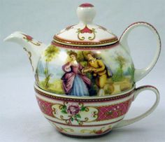 a tea pot with a painting on it