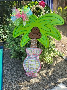 a paper cut out of a palm tree with flowers in the background and an umbrella