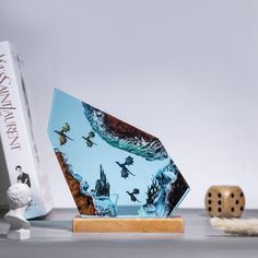 a book and dice sitting on top of a table next to a board game box