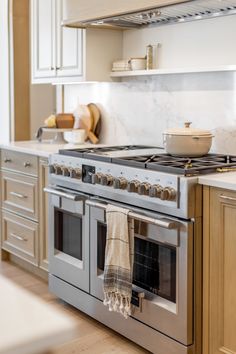 a kitchen with an oven, stove and cabinets