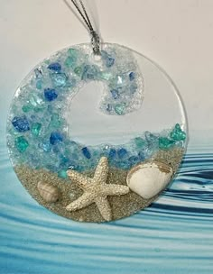 a glass ornament with sea shells and starfish