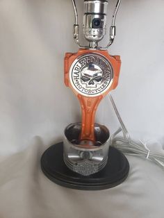 an orange and silver robot is sitting in a cup