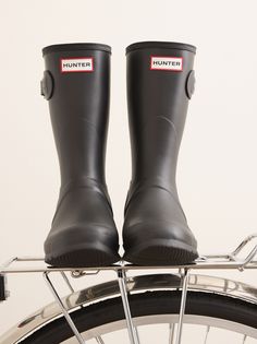 The Women's Original Short Rain Boot is a shorter version of the iconic Hunter Original Tall Boot and perfect for wet-weather conditions. Formed of natural rubber, each boot is handcrafted and assembled over three days before being vulcanised for superior protection. The Hunter Original tread pattern and comfortable 100% recycled polyester lining completes the design on this 100% waterproof boot. Waterproof Boots With Round Toe In Recycled Rubber, Waterproof Recycled Rubber Boots With Round Toe, Outdoor Weatherproof Boots With Recycled Rubber, Weatherproof Outdoor Boots With Recycled Rubber, Black Boots With Recycled Rubber Sole, Outdoor Boots With Recycled Rubber Sole, Outdoor Recycled Rubber Boots With Round Toe, Weatherproof Recycled Rubber Boots For Outdoor, Recycled Rubber Boots With Round Toe And Rubber Sole