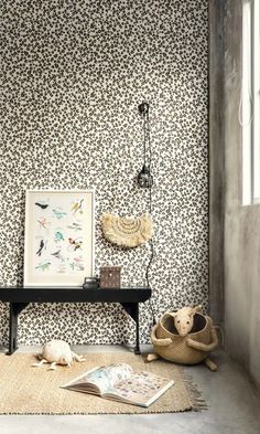 an animal print wallpaper in a living room next to a table with a magazine on it