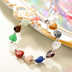 Experience elegance and playfulness with our Natural Stone Heart Beaded Bracelet! This bracelet showcases a stunning array of heart shaped natural stones, each one carefully selected for its unique hue and texture. Each colorful stone is handpicked to inspire unique beauty. Perfect for holidays and beach adventures in a hot summer day. Show your love for nature with this one of a kind piece! DETAILS Materials: Brass, Natural Stones Measurements: Length: 6.69"(17cm)+Extender: 1.57"(4cm) Weight: 1 Heart-shaped Beaded Bracelets With Natural Stones For Gift, Heart-shaped Natural Stone Beaded Bracelets For Gifts, Heart-shaped Natural Stone Beaded Bracelets As Gift, Heart-shaped Natural Stone Beaded Bracelet Gift, Spiritual Heart Beads Bracelet Gift, Bohemian Crystal Bracelet With Heart Beads, Heart-shaped Gemstone Beads Bracelets For Gift, Heart-shaped Healing Beaded Bracelets, Heart-shaped Gemstone Beads Bracelets As Gift