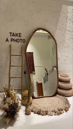 there is a mirror and some plants on the table