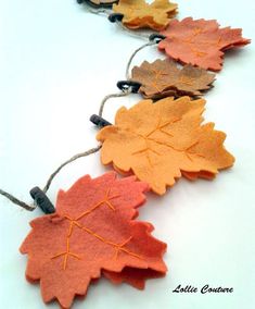 an image of fall leaves on string