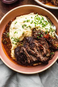 a bowl filled with meat and mashed potatoes